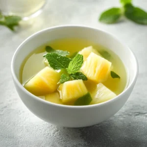 The Refreshing Iced Pineapple Mint Green Tea is the ideal drink for those warm days when you crave something invigorating yet soothing. This beverage masterfully combines the vibrant health benefits of green tea with the tropical sweetness of fresh pineapple and the aromatic freshness of mint. This delightful concoction not only quenches your thirst but also offers an aromatic experience that dances on the palate.