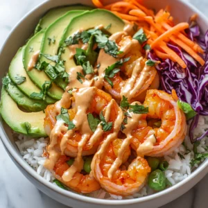 This recipe for Zesty Shrimp Rice Bowls with Creamy Spicy Mayo Drizzle is a vibrant and flavorful dish that showcases the deliciousness of shrimp alongside fresh vegetables. The combination of marinated shrimp and colorful toppings, such as avocado and red cabbage, not only creates an appealing visual but also provides a delightful medley of textures and flavors. Each bite bursts with freshness, making this bowl a staple for anyone looking for a healthy yet satisfying meal.