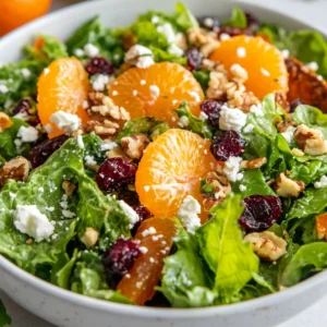 The Mandarin Mixed Green Salad is a refreshing and flavorful dish that combines the sweetness of mandarin oranges, the crunch of nuts, and the tanginess of feta cheese, all on a bed of mixed greens. This salad is perfect for a quick and easy lunch or dinner, and its colorful presentation makes it an excellent choice for special occasions or gatherings. The combination of flavors and textures in this dish makes it a perfect choice for various occasions, ranging from casual get-togethers to more formal events. Not specified in the recipe is the exact time of year or season when this salad is best served, but its refreshing qualities make it suitable for any time.