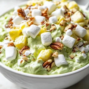 The Watergate Salad is a classic dessert that has been enjoyed for generations. It is a refreshing and tasty treat that is perfect for any occasion. With its unique combination of pistachio pudding mix, crushed pineapple, and Cool Whip, this salad is sure to be a hit with your guests. The best time to serve this salad is during warm weather or at outdoor gatherings, as it provides a cool and refreshing treat. Not specified in the recipe is the specific taste or flavor profile, but it can be inferred that the combination of ingredients provides a sweet and satisfying experience.